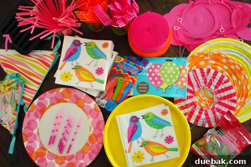 Earthworm Extravaganza Birthday 7 Table laden with worm-themed party supplies for Clara's second birthday, including plates, candles, and decorations.