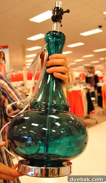 Giant blue glass lamps with white shades, perfect for adding coastal elegance to any room.