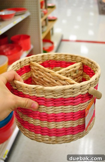 White utensil basket with handles, practical for carrying items for outdoor dining or organizing.