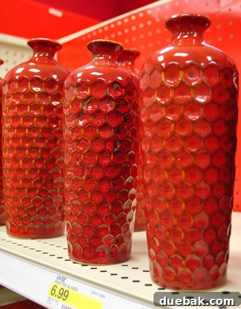 Hexagonal ceramic vases in muted tones, inspired by honeycomb patterns, ideal for small floral arrangements.