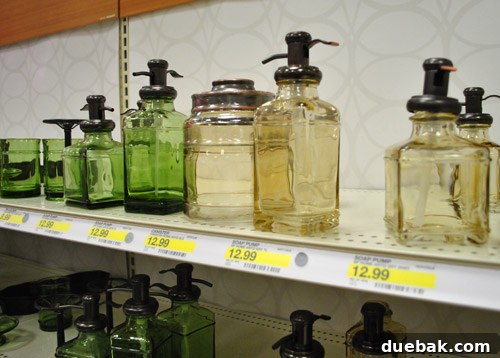 Glass soap pumps and bathroom accessories with an 'old apothecary' style, adding vintage charm.