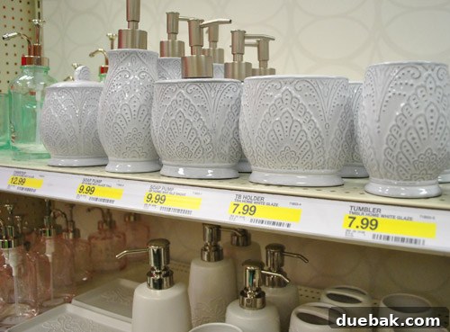 White bathroom accessories with tribal-inspired detailing, offering a sophisticated and worldly aesthetic.