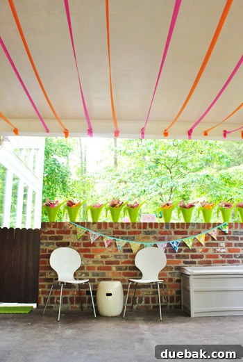 Clara's party setup featuring a toy storage bin next to outdoor chairs.