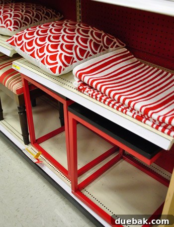 Americana themed home decor, featuring red and white patterned rugs, decorative pillows, and modern side tables.