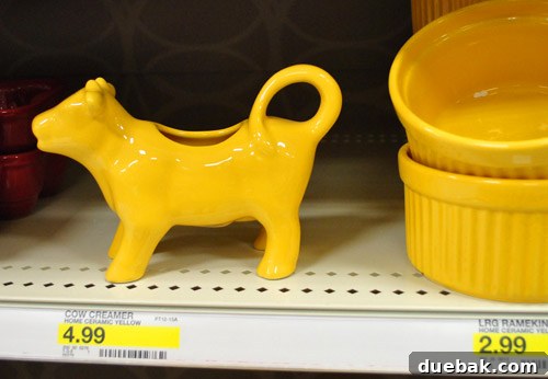 Yellow ceramic cow creamer, repurposed as a charming vase, adding a whimsical touch to kitchen or dining decor.