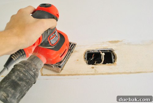 Sanding the wall behind the light fixture