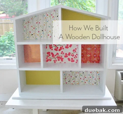 Hand-built wooden dollhouse structure with multiple rooms