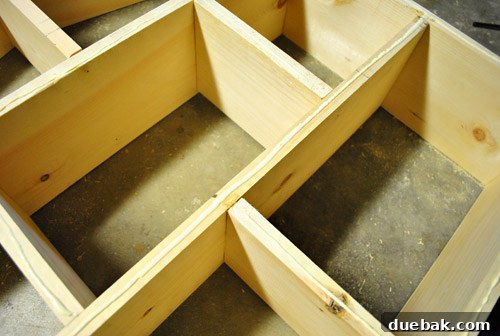 Nailing the plywood back panel onto the dollhouse frame