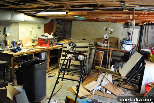 Before image of a messy basement workshop