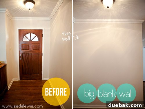 Entryway before renovation: a plain, blank wall next to the front door
