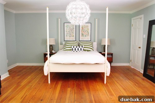 The bare bedroom floor after removing the old rug, highlighting the need for a new floor covering.