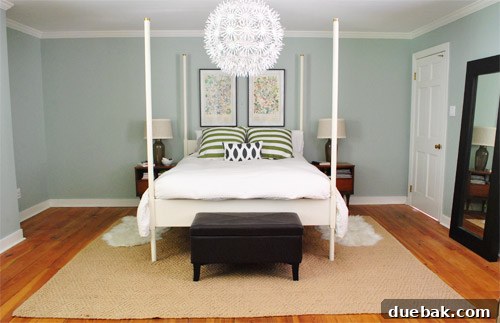 Bedroom before the new rug, featuring a simple jute rug and unfinished decor.