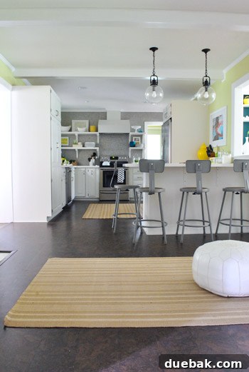 Old honey-oak colored kitchen rugs that are too small and clash with avocado walls