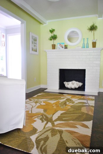 The Pottery Barn Clara rug's honey-wheat tones clashing with the subtle avocado walls