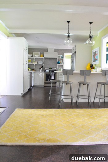 A beloved yellow Moorish pattern Pottery Barn rug from the guest room in the kitchen