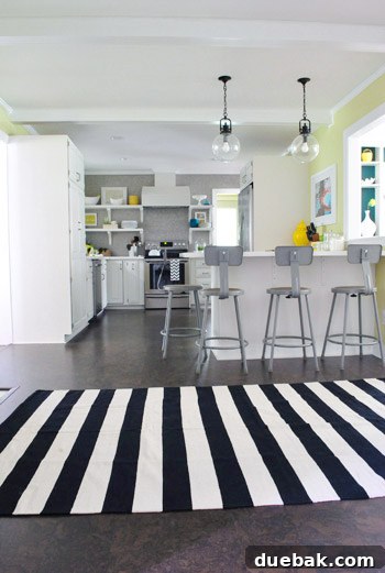 One black and white striped rug placed in the fireplace zone of the kitchen