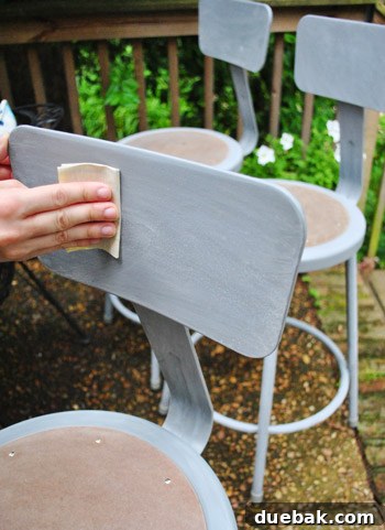 Metal Stool Makeover Spray Paint Edition 12 Sanding the metal stool with 300-grit sandpaper for paint adhesion
