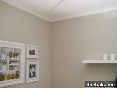 Close-up view of a perfectly installed white crown molding, showcasing the crisp lines and intricate profile against a soft wall color.