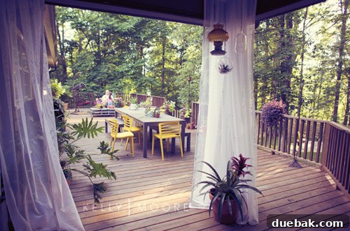 House Crashing: Kelly's Outdoor Escape Revealed 5 A beautifully decorated outdoor deck with a hanging egg chair and drapes