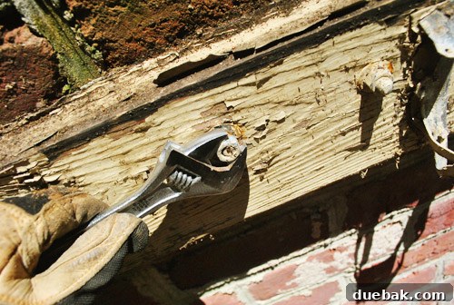 Reclaiming Space: From Balcony to Spacious Deck 11 Close-up of bolts still embedded in the brick wall after the old ledger board has been removed, highlighting wood rot