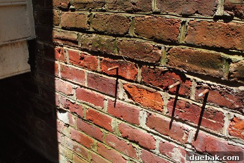 Reclaiming Space: From Balcony to Spacious Deck 12 The brick wall, clean of the old balcony, with only the old anchor bolts remaining visible