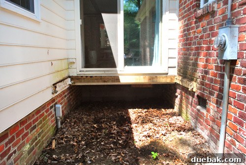 Reclaiming Space: From Balcony to Spacious Deck 6 A weathered ledger board securely bolted into the brick façade of the house