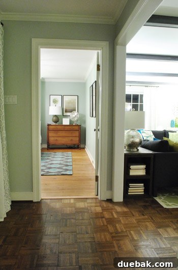 New view of bedroom from hallway, showing dresser in nook