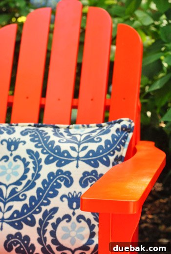 Bringing a Pop of Color to Our Side Patio with Red Adirondacks 11 Another view of a new red Adirondack chair on a patio