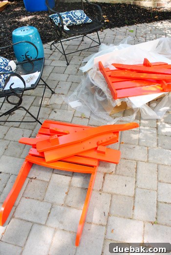 Bringing a Pop of Color to Our Side Patio with Red Adirondacks 18 Two newly assembled red Adirondack chairs on the patio, awaiting use
