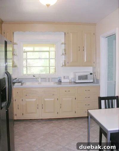 Bright, updated kitchen after painting old cabinets white, showing a significant transformation