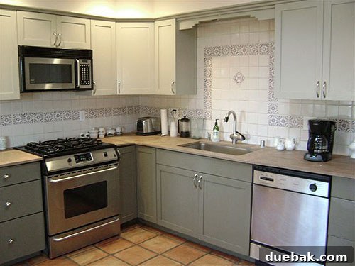 Kim's renovated kitchen with two-tone painted cabinets, light uppers and darker lowers