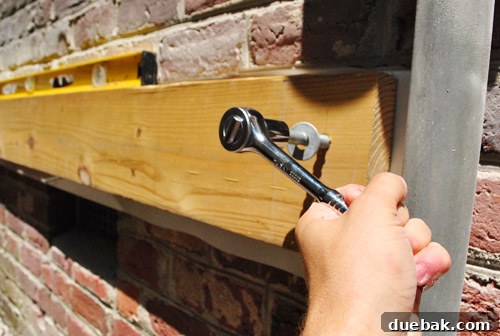 Sourcing Your Deck Building Materials 14 Hand-wrenching a lag screw into the ledger board