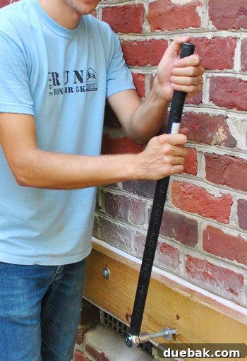 Sourcing Your Deck Building Materials 15 Using a scrap pipe to extend wrench handle for leverage