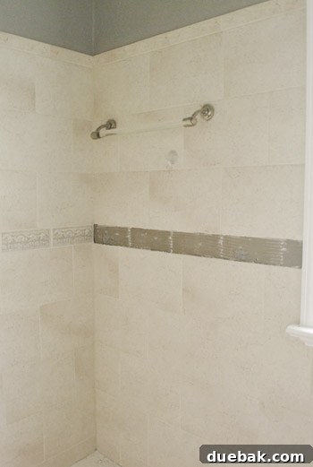The bathroom wall after all old tiles have been successfully removed, showing a clean, ready surface for new tile