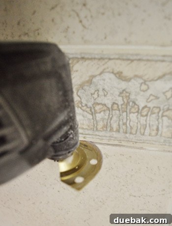 The Dremel Multi-Max efficiently cutting a straight line through grout during bathroom tile removal