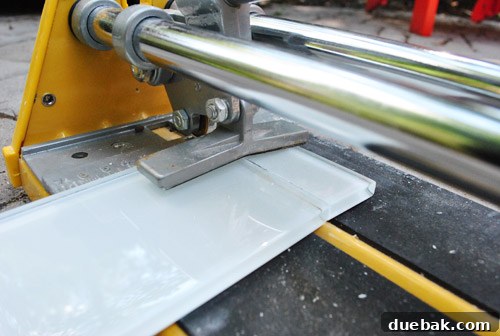 Using a wet saw for precise, intricate tile cuts around a light switch or other fixture