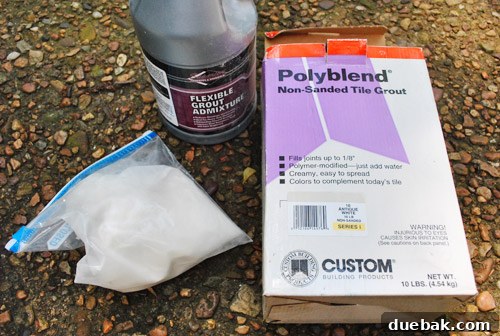 Applying grout evenly to newly installed glass subway tiles using a grout float