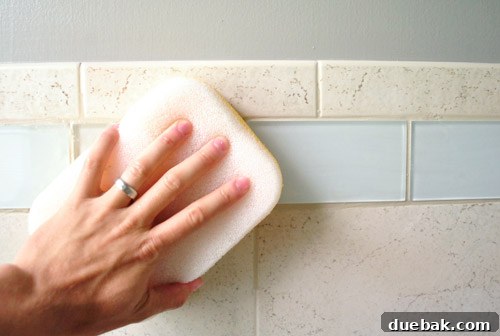 Applying grout sealer to protect tile lines from moisture and stains, ensuring longevity