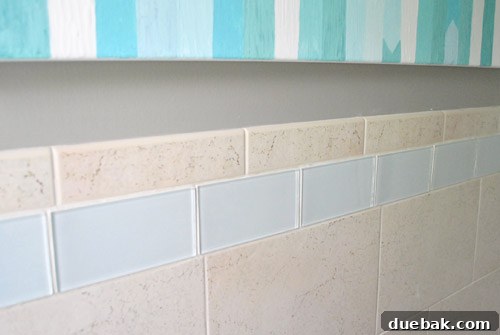 Seamless integration of new glass tile with existing grout color, creating a cohesive look