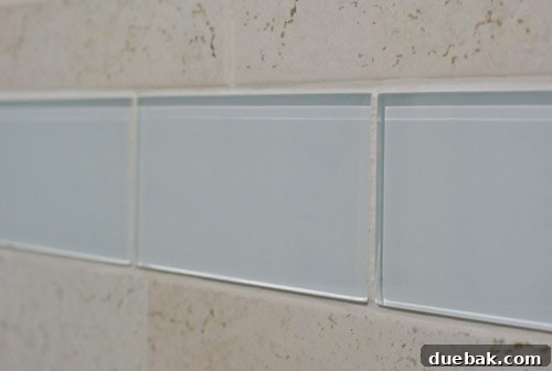 Wet glass tiles beautifully reflecting light and water droplets on their clear surface