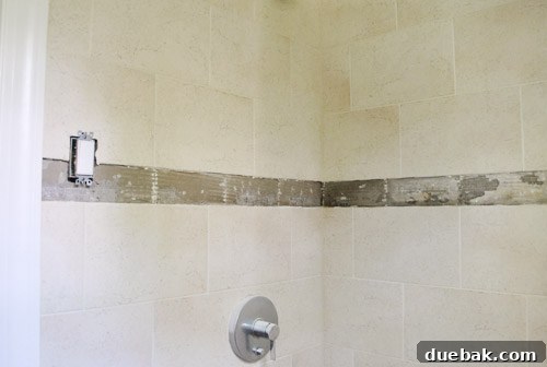 Box of clear glass subway tiles, 'Glass Snow,' chosen for the bathroom renovation