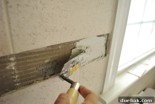 Creating uniform ridges in thinset with a notched trowel for optimal tile adhesion