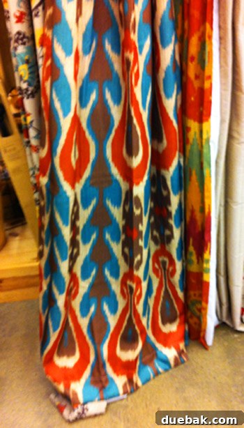 Red, blue, white, and brown patterned curtain panel