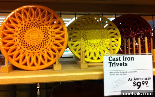 Intricate cast iron trivets in bold colors