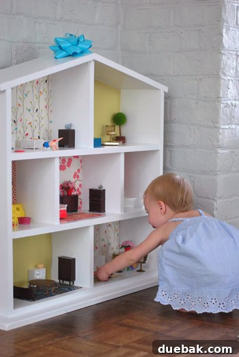 Original, unedited photo of Clara and her dollhouse for editing demonstration