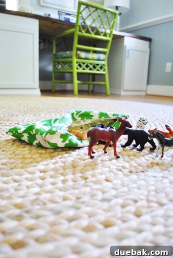 Elevating Our Home with the Right Rugs 11 Child's plastic animal parade on the new jute rug, highlighting its family-friendly and playful nature.