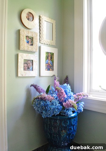 Every Year, A New Frame 14 Close-up of the framed anniversary photo collection on the wall, including an empty frame for the next year