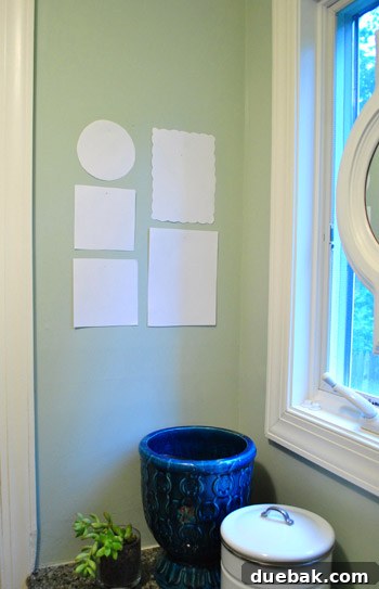 Every Year, A New Frame 8 Taping paper templates of photo frames to the wall to finalize placement