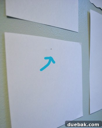 Every Year, A New Frame 9 Marking the exact nail hole position on a paper frame template for accurate hanging