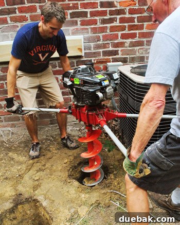 Man's concentrated face while operating auger